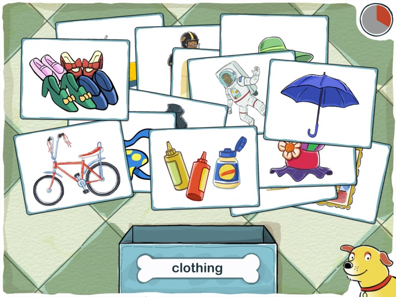 An app screen showing playing cards arranged in a messy pile. Each card has an image on it: shoes, a bicycle, condiments, an umbrella and an astronaut. There's a box at the bottom of the screen with a label on it that reads, “clothing.”
